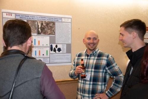 Three intrepid scholars study during the poster session